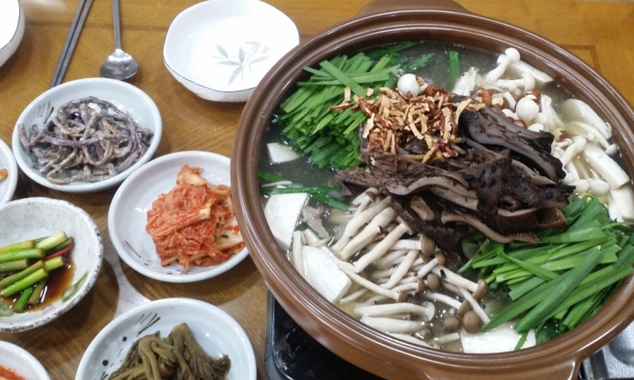 여러 재료가 든 냄비와 밑반찬 사진
